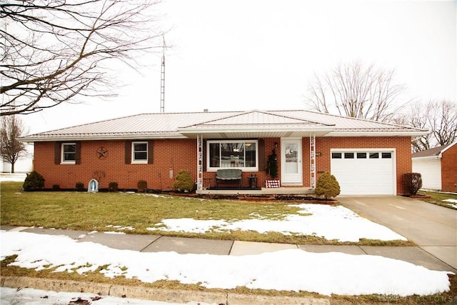 ranch-style home with covered porch, a garage, and a lawn