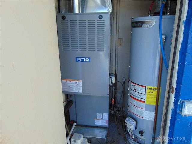 utility room with water heater and heating unit