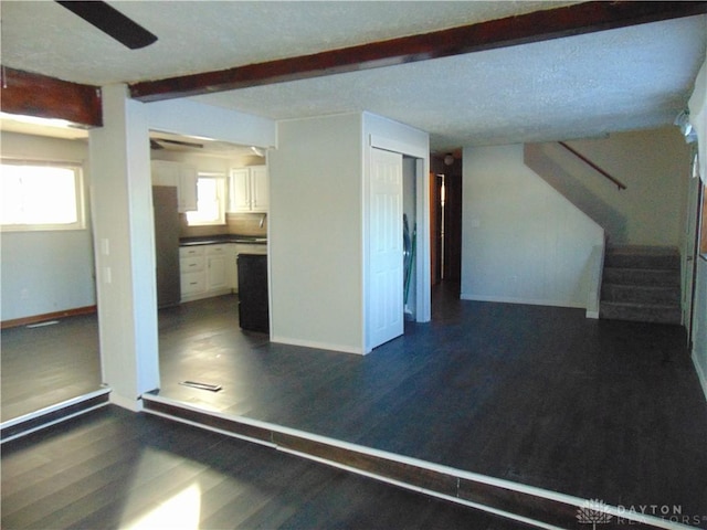 interior space with beam ceiling and dark hardwood / wood-style floors