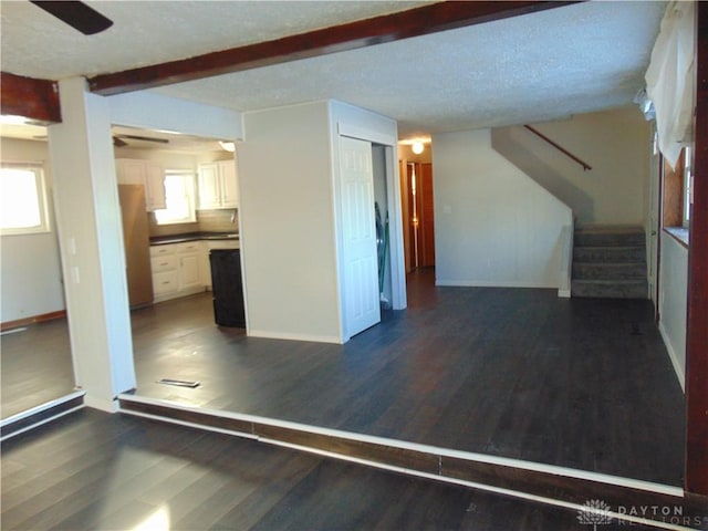 interior space featuring dark hardwood / wood-style flooring and beam ceiling