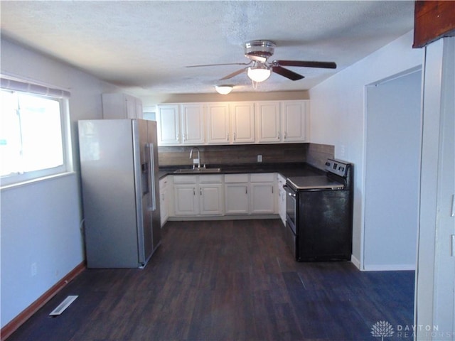 kitchen featuring electric range, sink, white cabinetry, and high end fridge