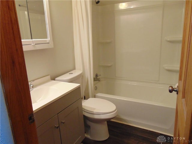 full bathroom with hardwood / wood-style flooring, shower / tub combination, toilet, and vanity