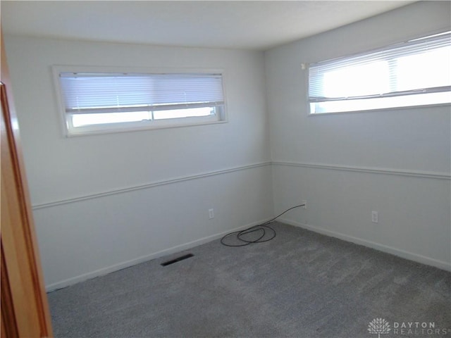 empty room featuring dark carpet