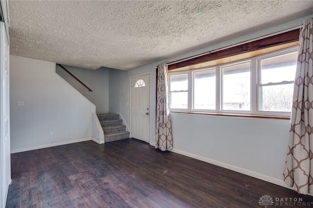 5254 Powell Rd, Dayton, OH 45424 - foyer entrance with dark wood finished floors, baseboards, stairway, and a textured ceiling