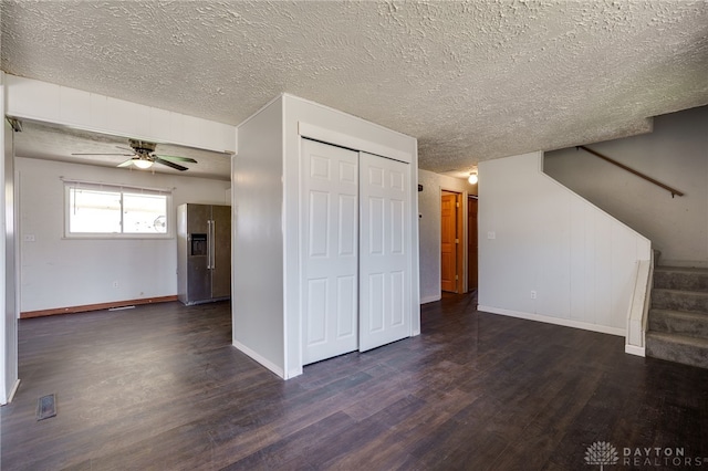 5254 Powell Rd, Dayton, OH 45424 - unfurnished living room with stairs, wood finished floors, ceiling fan, baseboards, and a textured ceiling
