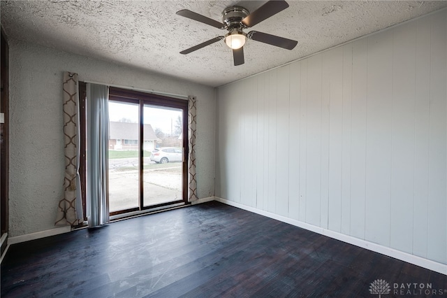 5254 Powell Rd, Dayton, OH 45424 - unfurnished room featuring dark wood-style flooring, a textured ceiling, ceiling fan, and baseboards