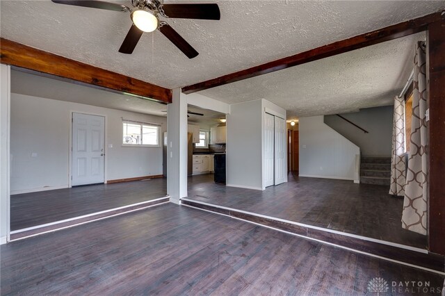 5254 Powell Rd, Dayton, OH 45424 - unfurnished living room with a textured ceiling, wood finished floors, stairway, baseboards, and beam ceiling