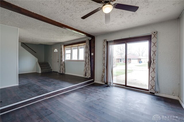 5254 Powell Rd, Dayton, OH 45424 - unfurnished room featuring a textured ceiling, stairs, a ceiling fan, wood finished floors, and baseboards