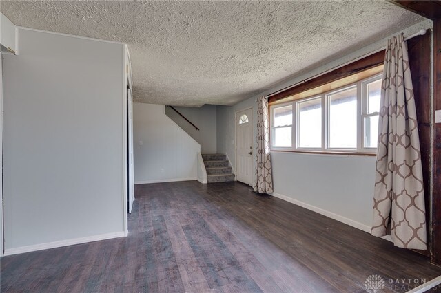 5254 Powell Rd, Dayton, OH 45424 - basement featuring dark wood finished floors, a textured ceiling, stairs, and baseboards