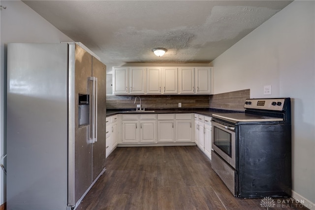 5254 Powell Rd, Dayton, OH 45424 - kitchen featuring appliances with stainless steel finishes, dark wood finished floors, dark countertops, white cabinetry, and a sink