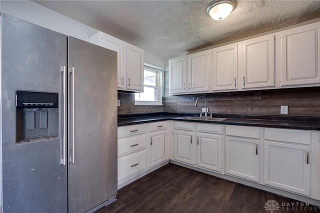 5254 Powell Rd, Dayton, OH 45424 - kitchen featuring stainless steel refrigerator with ice dispenser, a sink, dark countertops, dark wood finished floors, and a textured ceiling