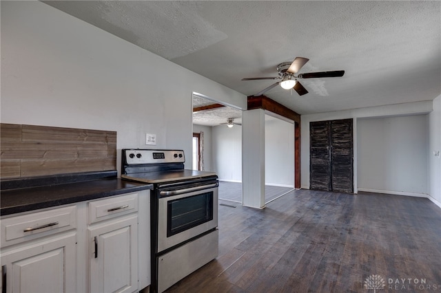 5254 Powell Rd, Dayton, OH 45424 - kitchen with electric range, a textured ceiling, ceiling fan, dark wood-type flooring, and dark countertops