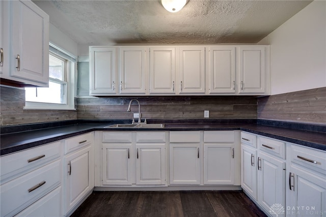5254 Powell Rd, Dayton, OH 45424 - kitchen with a sink, white cabinetry, dark countertops, and a textured ceiling