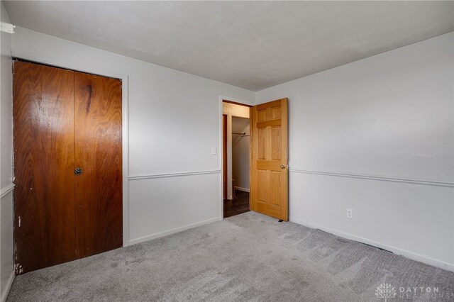 5254 Powell Rd, Dayton, OH 45424 - unfurnished bedroom featuring carpet flooring, baseboards, and a closet