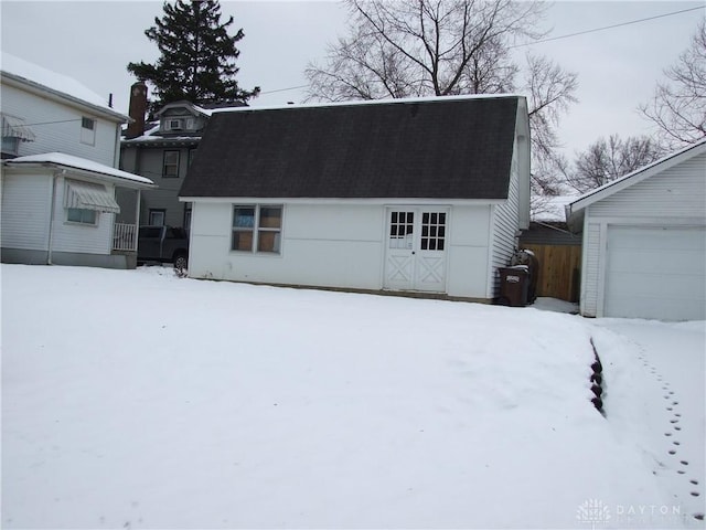 exterior space with a garage and an outbuilding