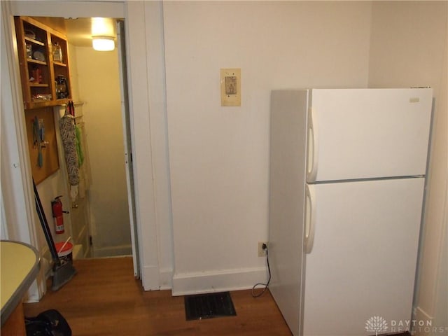 interior space with hardwood / wood-style floors and white refrigerator