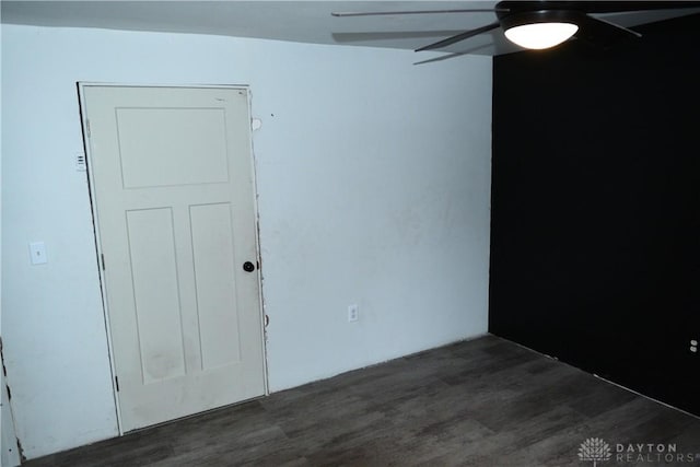 unfurnished room featuring ceiling fan and dark hardwood / wood-style flooring