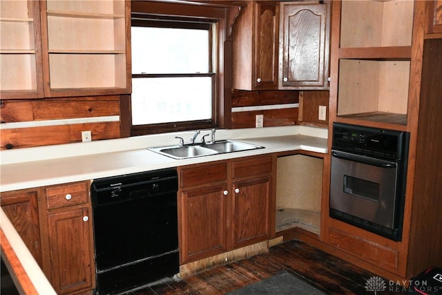 kitchen featuring black dishwasher, stainless steel oven, and sink