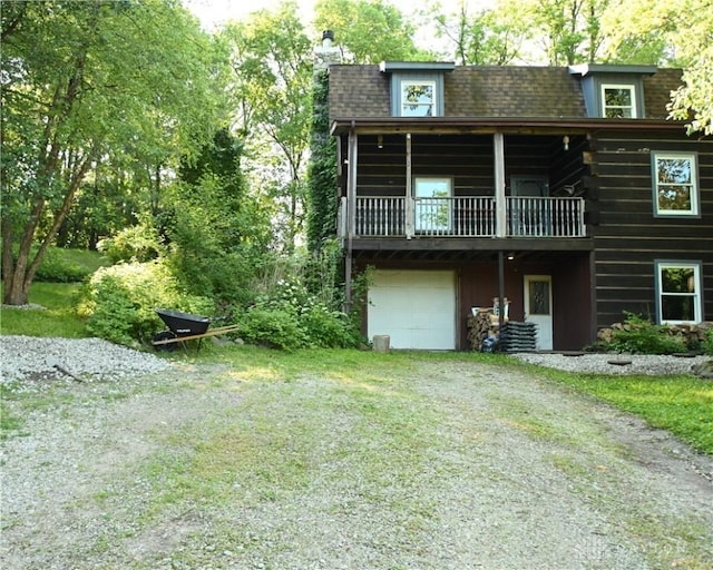 rear view of house featuring a garage