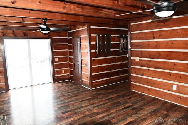 interior space featuring ceiling fan, dark hardwood / wood-style flooring, and wood walls