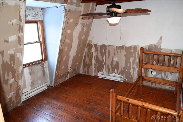 spare room with ceiling fan, dark hardwood / wood-style floors, and a baseboard radiator