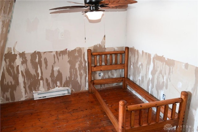 interior space featuring ceiling fan, baseboard heating, and hardwood / wood-style floors