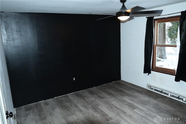 empty room with ceiling fan, hardwood / wood-style flooring, and a baseboard radiator