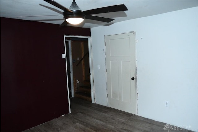 spare room with ceiling fan and dark hardwood / wood-style flooring