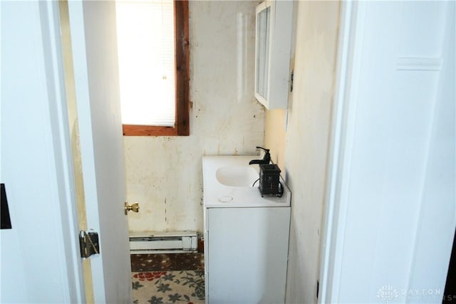 bathroom featuring baseboard heating and vanity