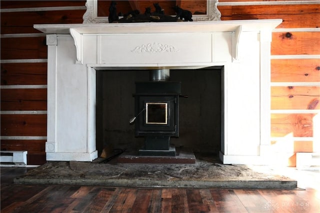 details with a wood stove, wood-type flooring, and wood walls