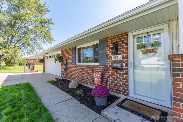 doorway to property with a garage