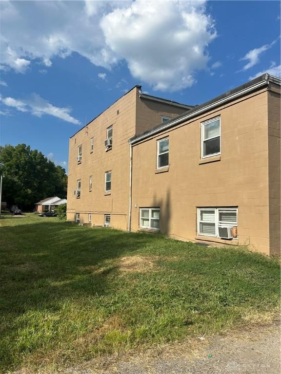 view of side of home with a lawn