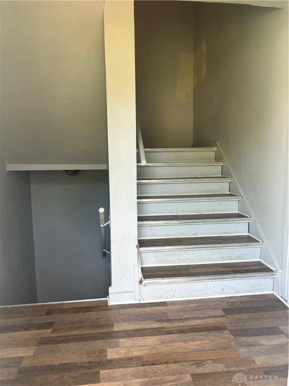 staircase with hardwood / wood-style floors