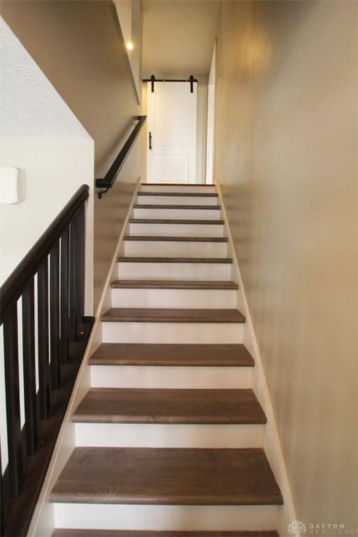 staircase featuring a barn door