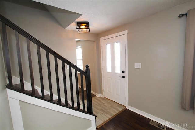 foyer entrance featuring hardwood / wood-style floors