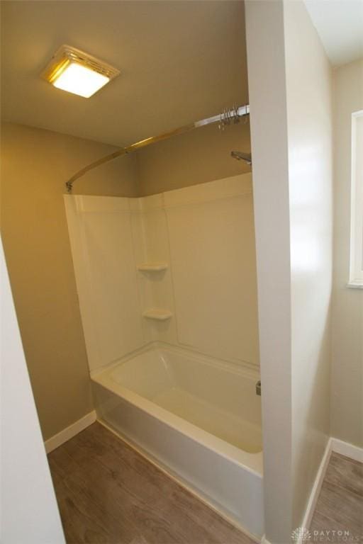 bathroom with hardwood / wood-style floors and shower / bathing tub combination