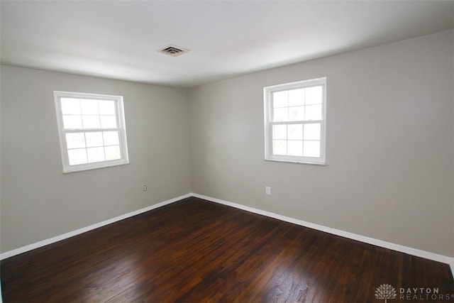 spare room with wood-type flooring