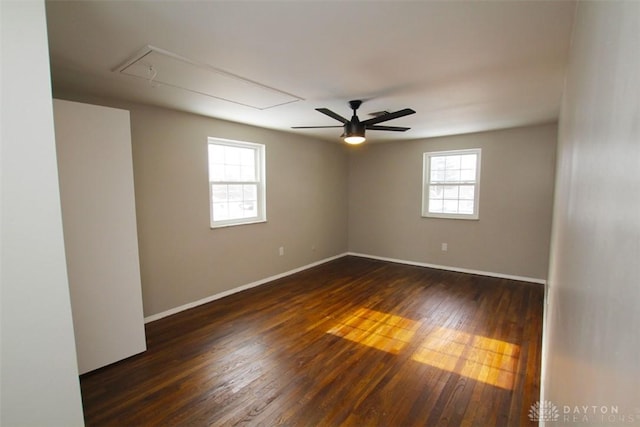 empty room with ceiling fan and dark wood-type flooring