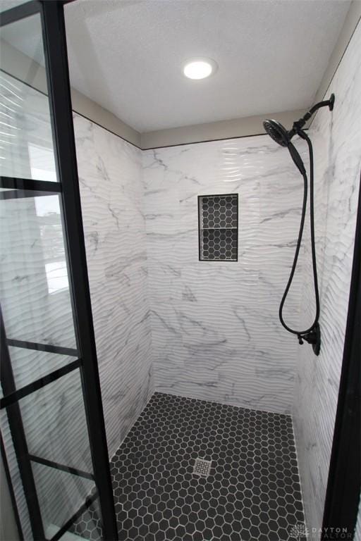 bathroom with a tile shower