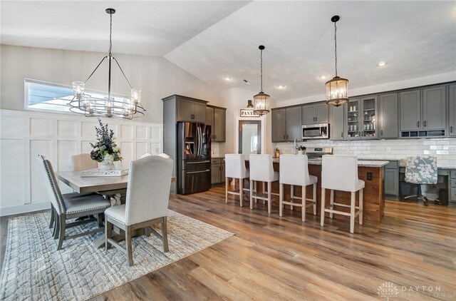 dining space featuring dark hardwood / wood-style flooring and a chandelier