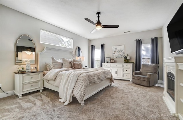 bedroom featuring ceiling fan and light colored carpet