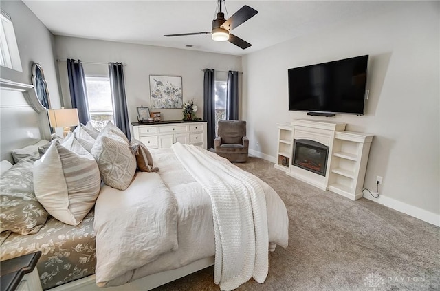 bedroom with ceiling fan and light carpet