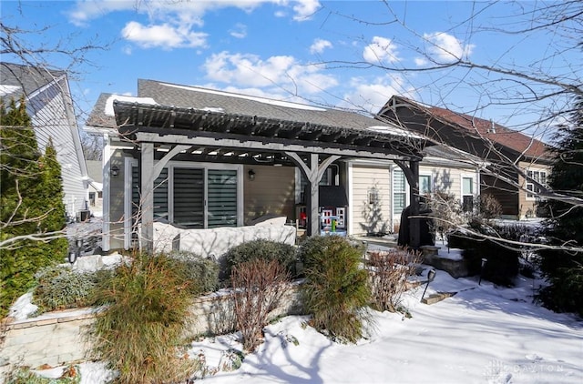 view of snow covered rear of property