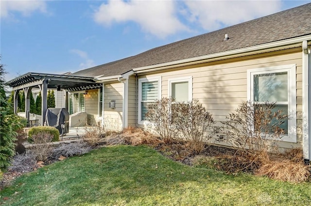 view of home's exterior with a pergola, a lawn, and a patio