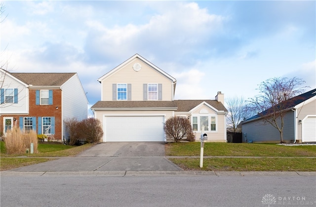 view of front of house featuring a garage and a front yard