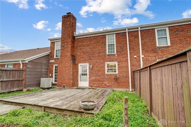 back of house featuring a deck and cooling unit