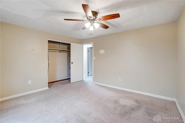 unfurnished bedroom with ceiling fan, a closet, and light colored carpet