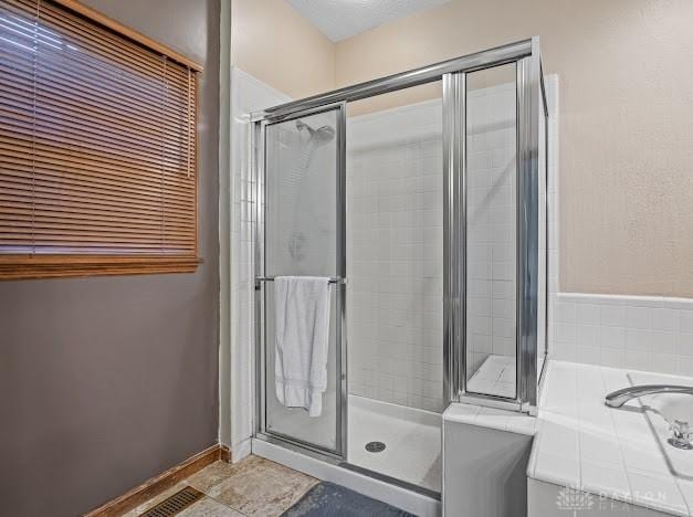 bathroom featuring a shower with door