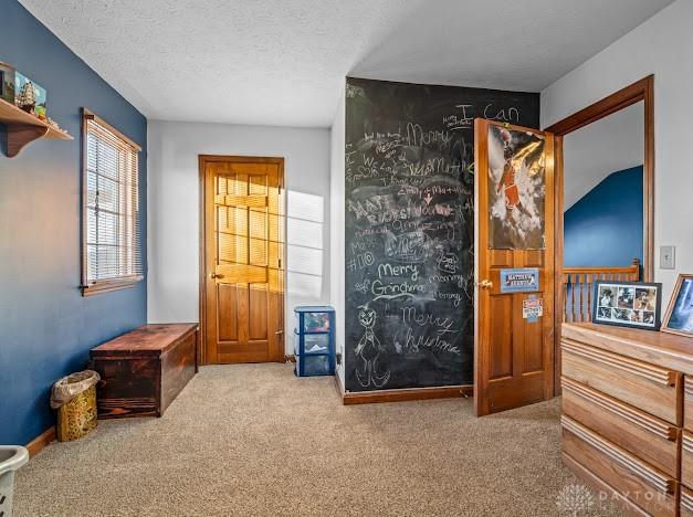 interior space with a textured ceiling and carpet