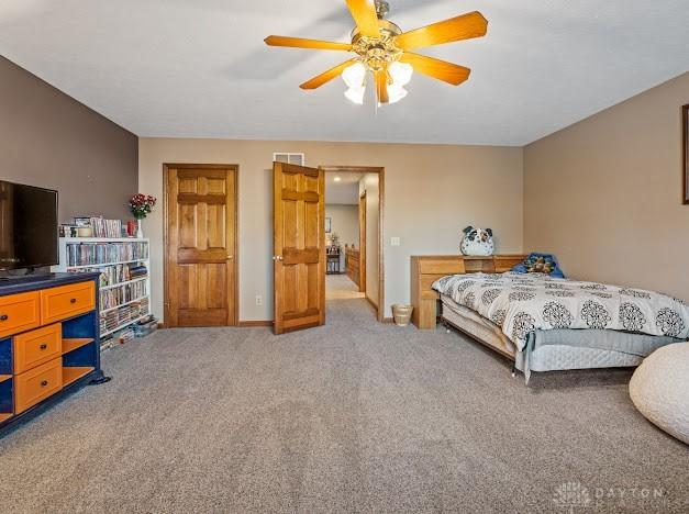 bedroom with ceiling fan and carpet floors